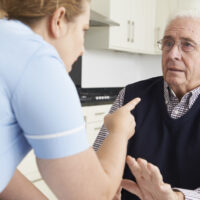 Care Worker Mistreating Elderly Man Care Worker Mistreating Elderly Man