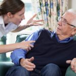 Care Worker Mistreating Senior Man At Home