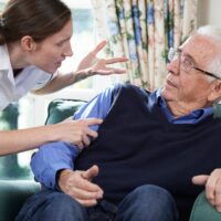 Care Worker Mistreating Senior Man At Home