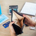 woman with financial problem during covid-19 virus pandemic hand open empty purse no money for credit card debt woman with financial problem during covid-19 virus pandemic hand open empty purse no money for credit card debt